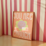 a picture frame sitting on a table next to a striped wall