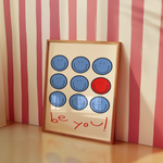 a picture frame sitting on a table next to a striped wall