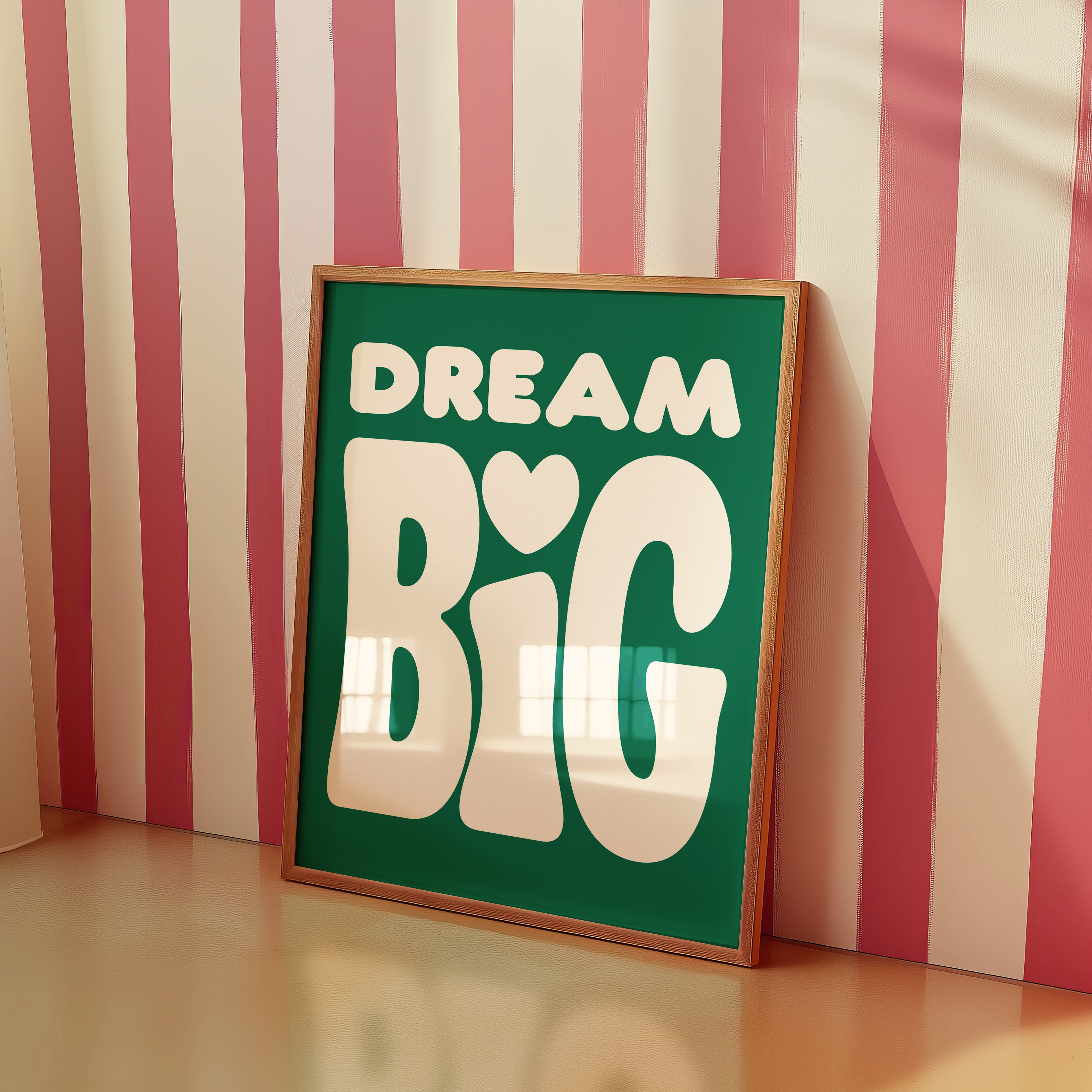 a picture frame sitting on a table in front of a striped wall