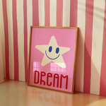 a pink picture frame with a smiling star on it