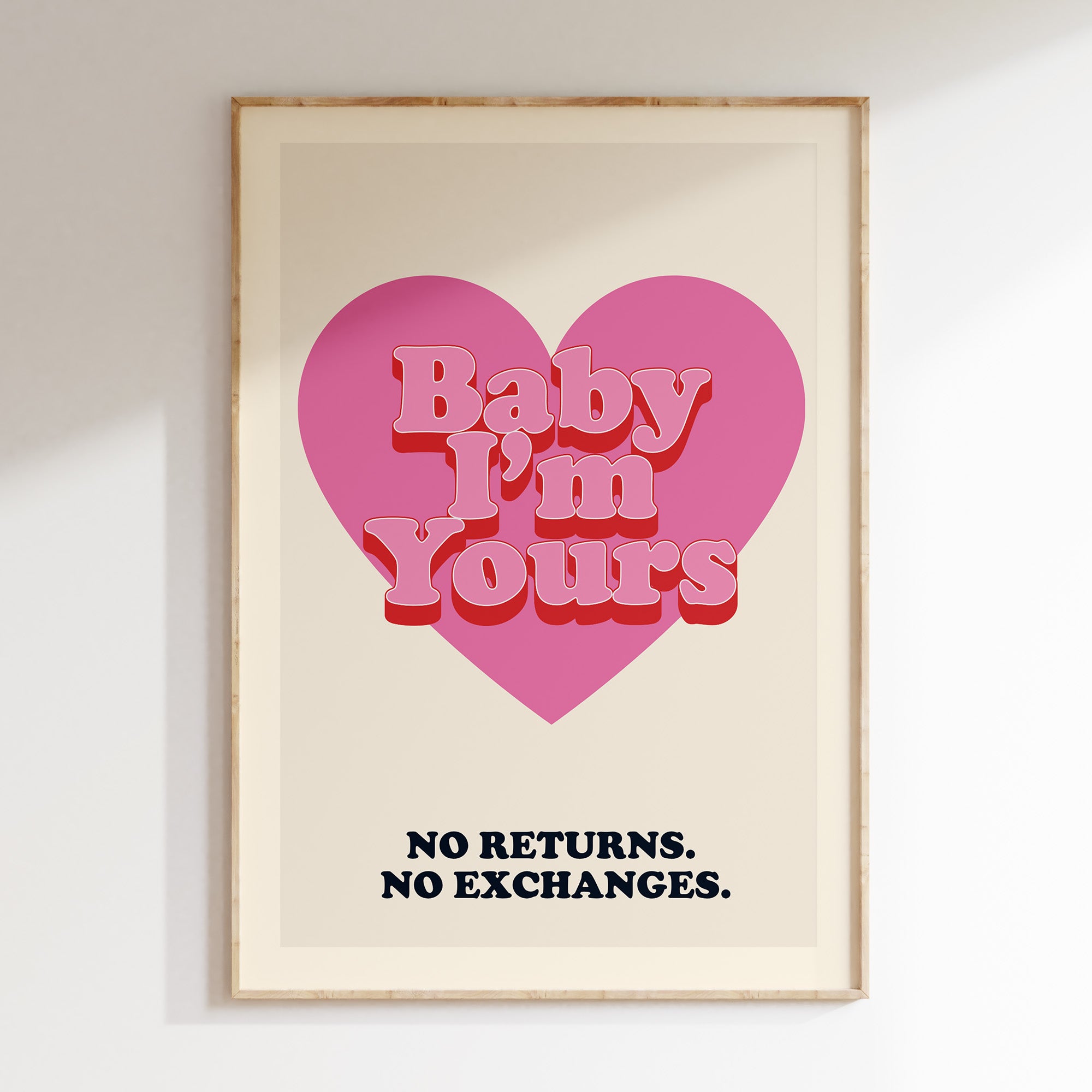 Baby I'm Yours retro print in oak frame, red heart with 'no returns no exchanges' caption on navy