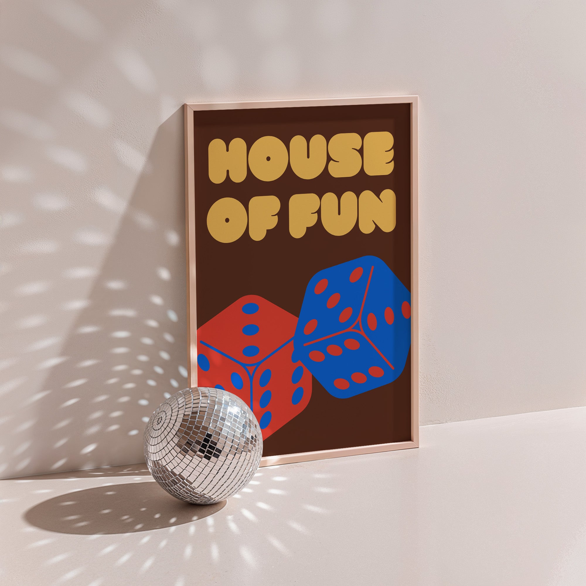 House Of Fun 2 (dice) poster in wood frame beside a disco ball, red and blue dice with yellow bubble lettering on brown