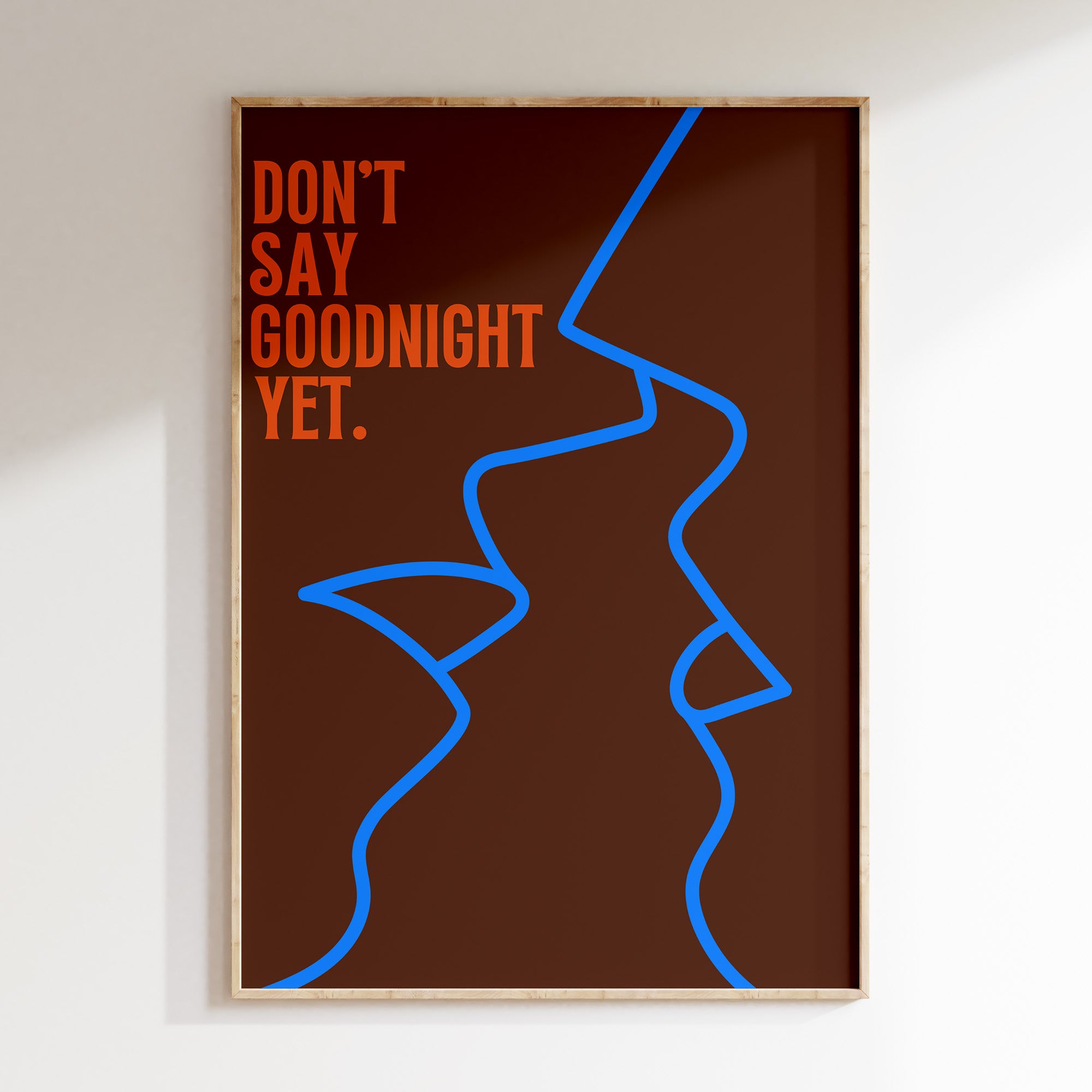 Don't Say Goodnight Yet retro print in oak frame, blue line-drawn faces with orange lettering on brown