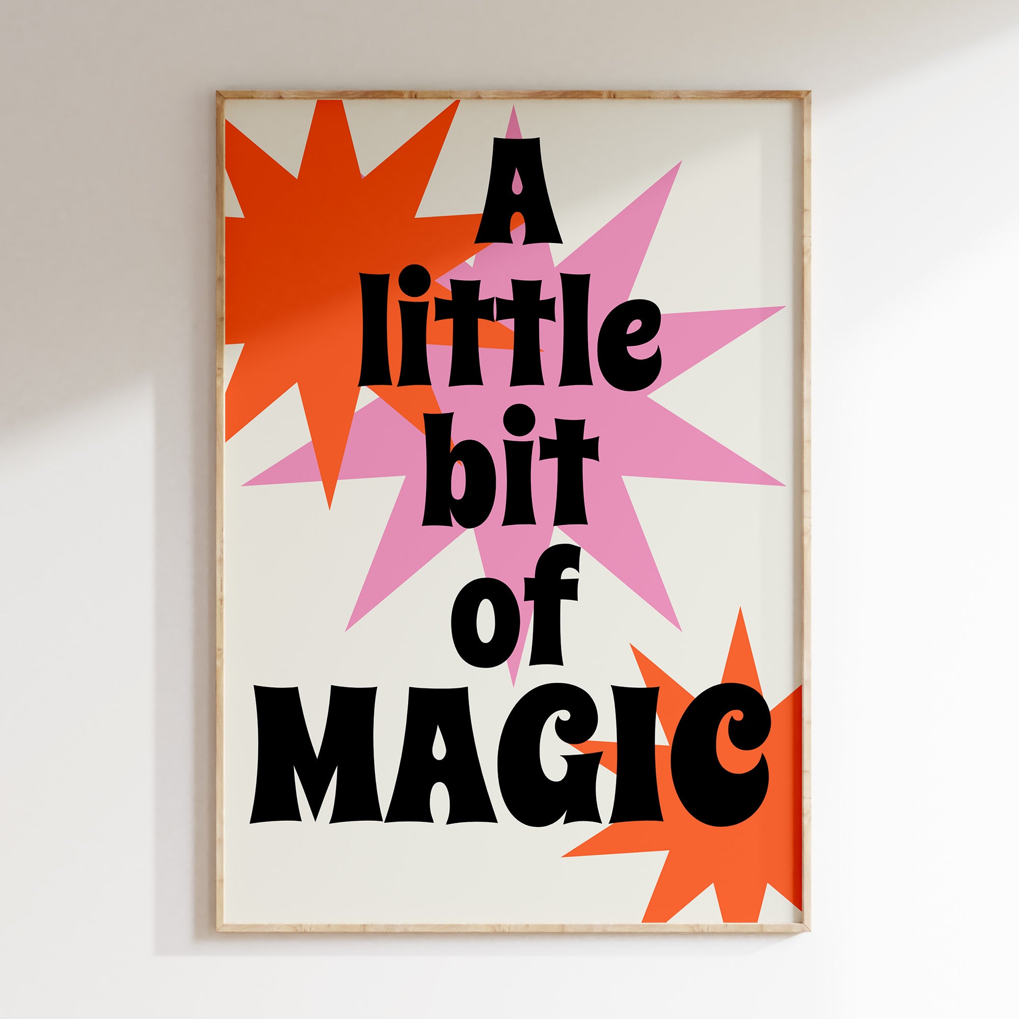 A Little Bit Of Magic typography print in oak frame, orange and pink starburst design with bold black retro lettering
