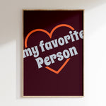 My Favorite Person retro print in oak frame, orange heart outline with grey lettering on burgundy