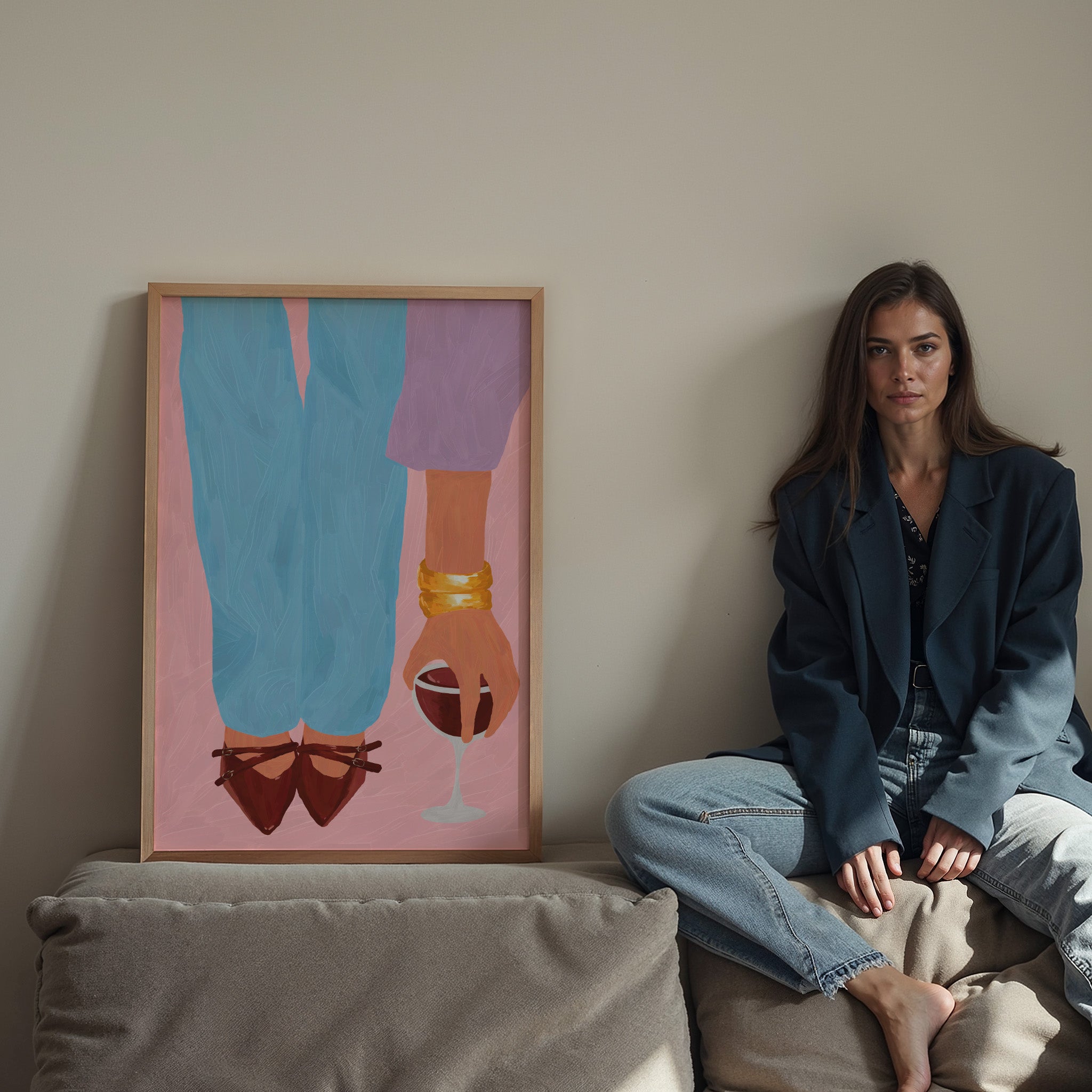 Woman sitting on a couch next to a colorful abstract painting on a wall.