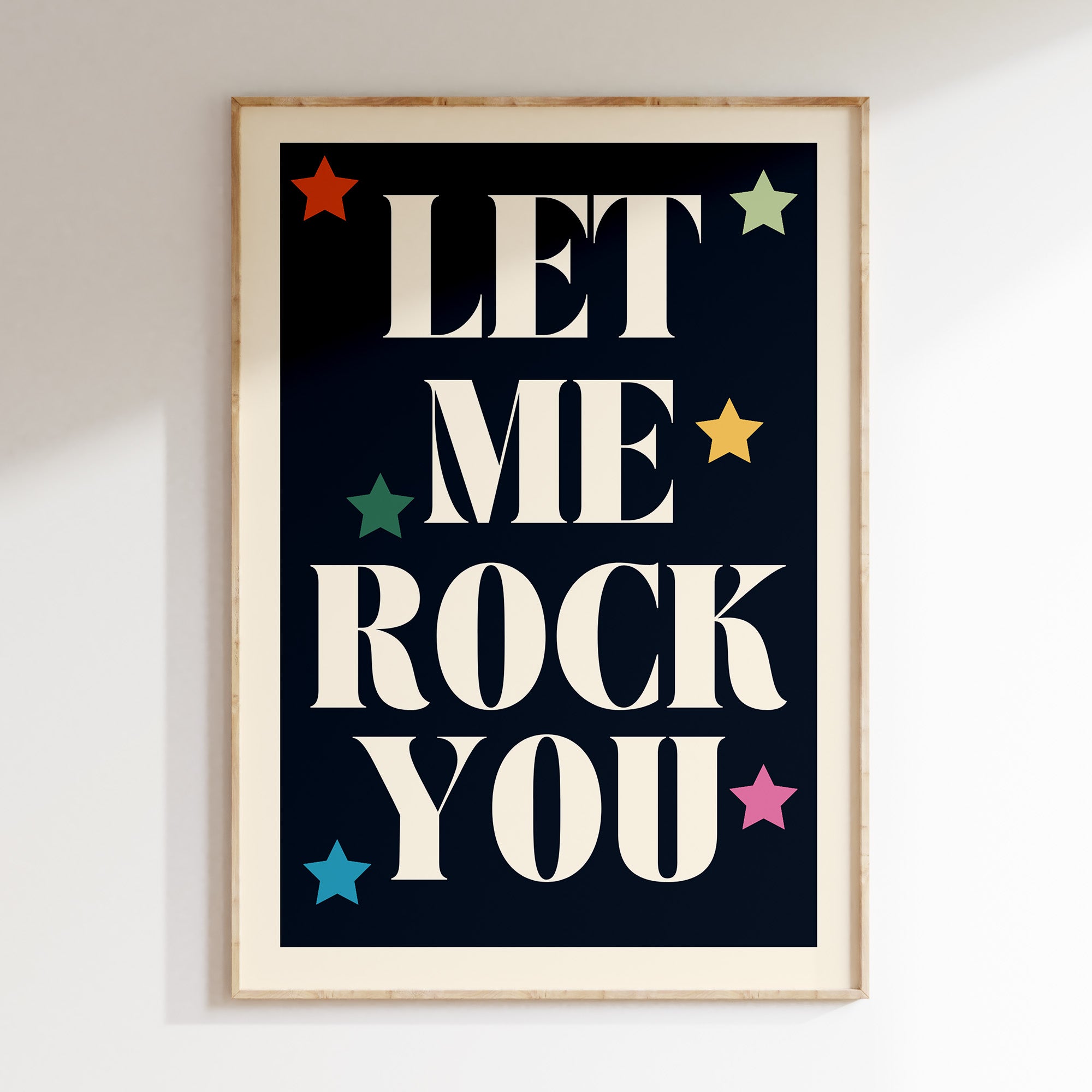 Let Me Rock You retro print in oak frame, cream serif lettering with multicoloured stars on navy