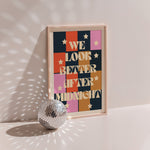 We Look Better After Midnight poster in wood frame beside a disco ball, colour-block grid with stars