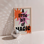 A Little Bit Of Magic retro poster in wood frame with disco ball, orange and pink starbursts, bold black lettering