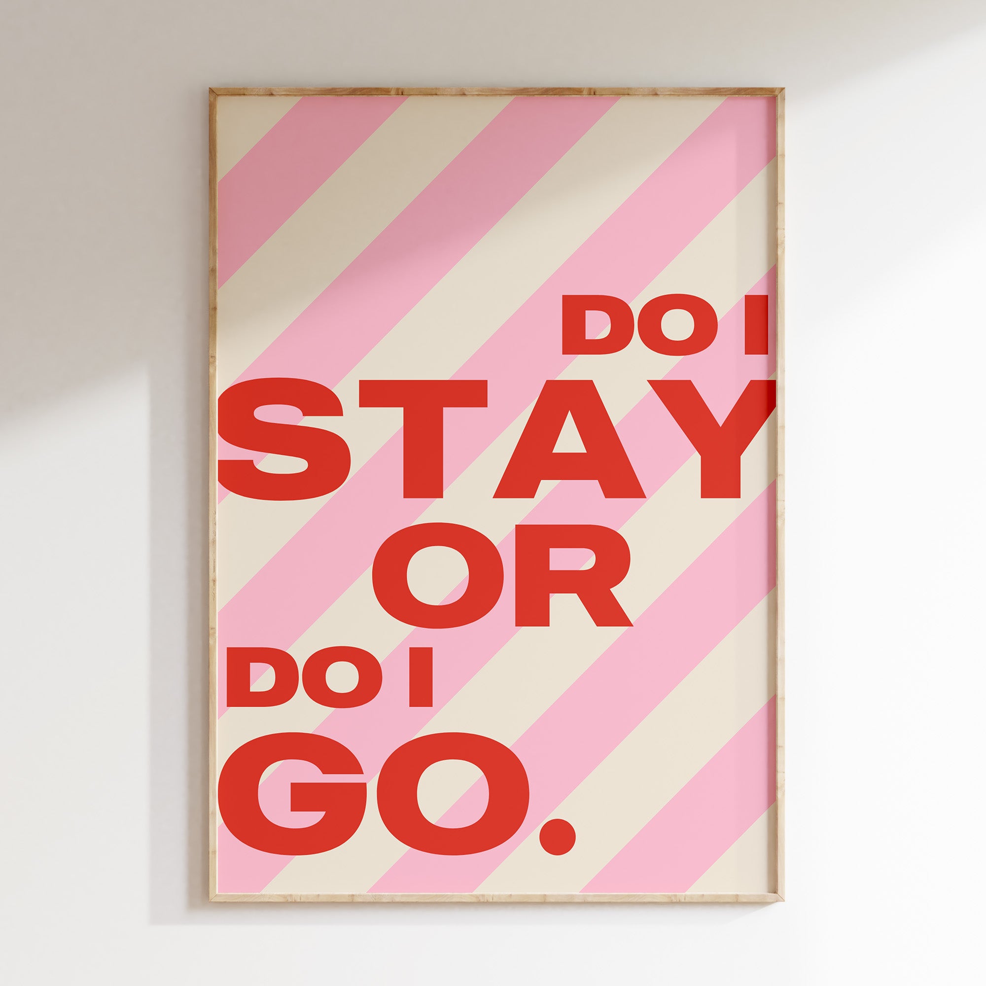 Do I Stay or Do I Go retro print in oak frame, bold red lettering on candy pink stripes