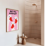 Bathroom with a pink poster asking 'Are you pooping?' and a shower enclosure.