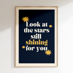 Look At The Stars retro print in oak frame, cream serif lettering with gold stars on navy