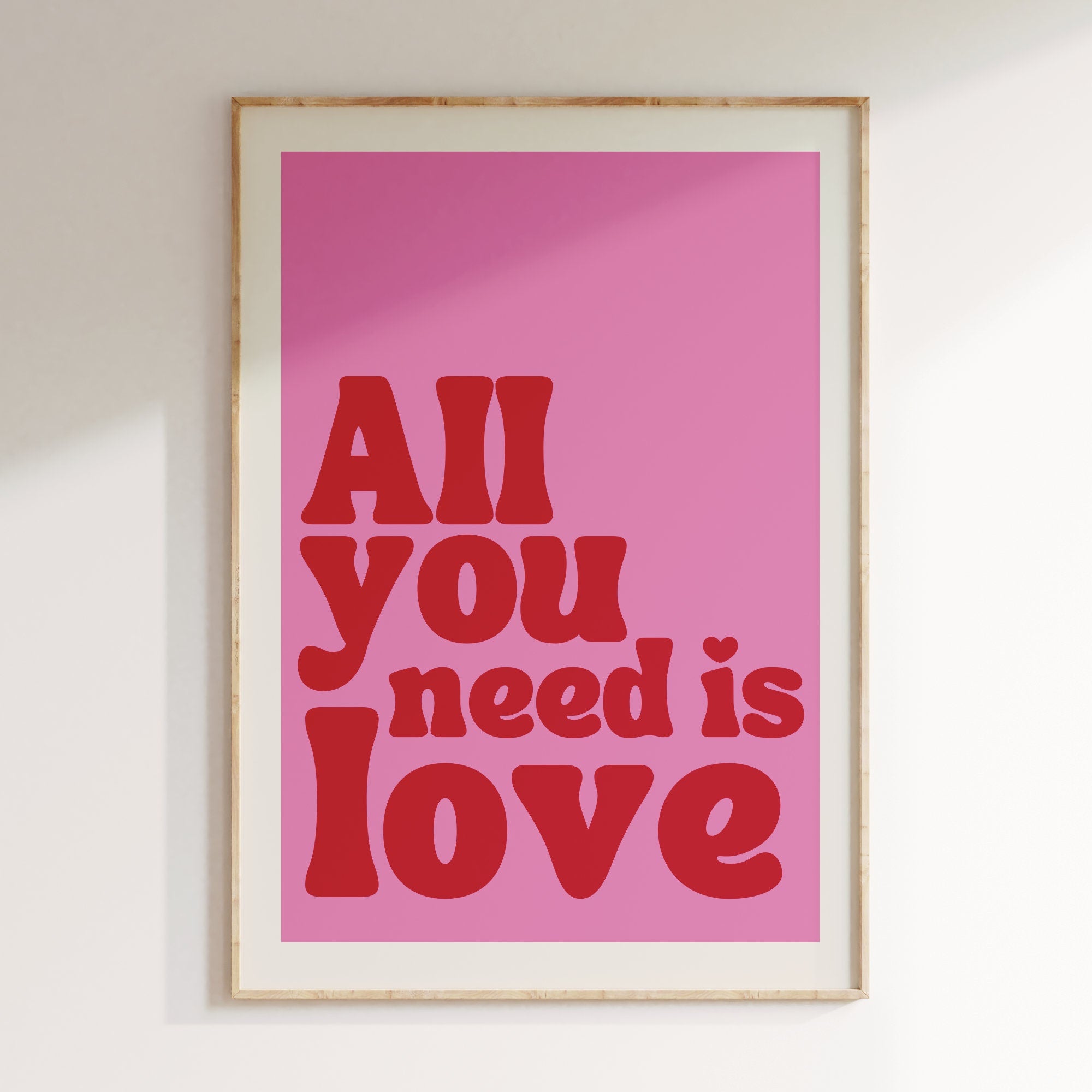 All You Need Is Love retro print in oak frame, pink background with red retro lettering