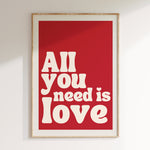 All You Need Is Love retro print in oak frame, red background with cream retro lettering