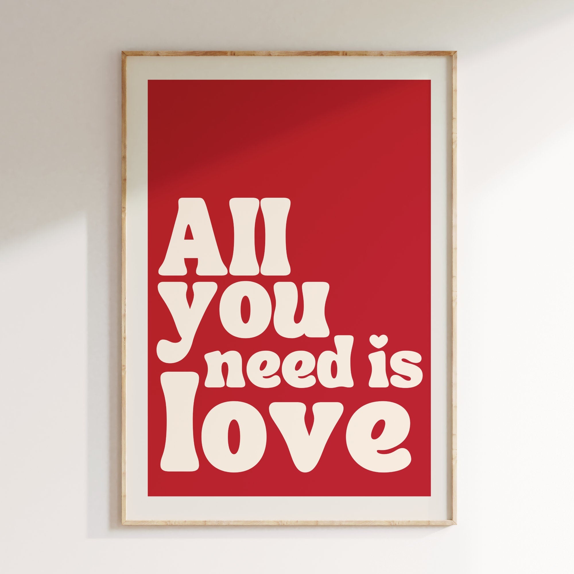 All You Need Is Love retro print in oak frame, red background with cream retro lettering