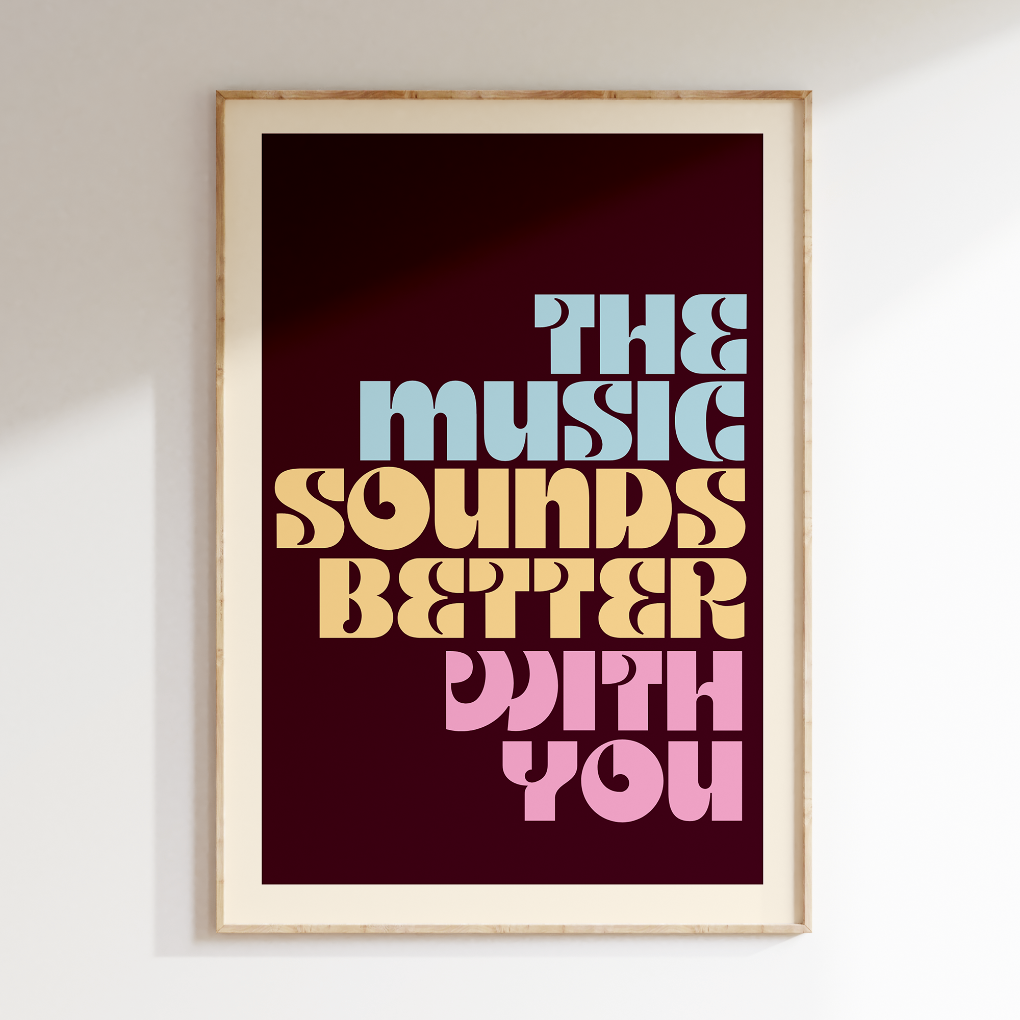 The Music Sounds retro print in oak frame, multicolor stacked lettering on burgundy