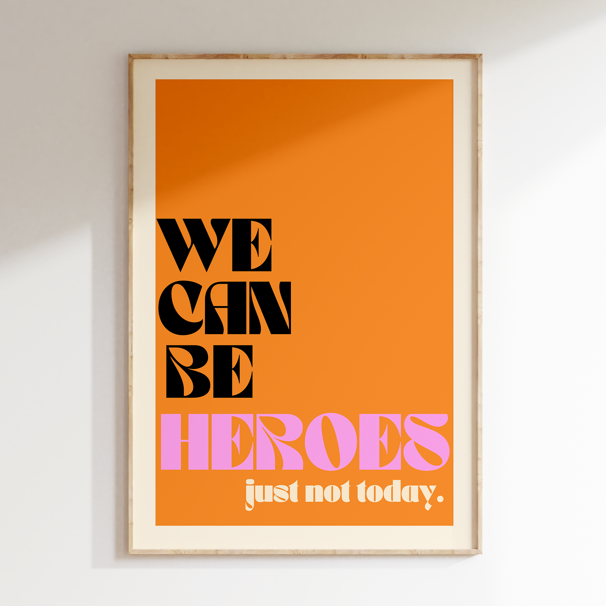 We Can Be Heroes retro print in oak frame, orange background with black and pink lettering and 'just not today' subline